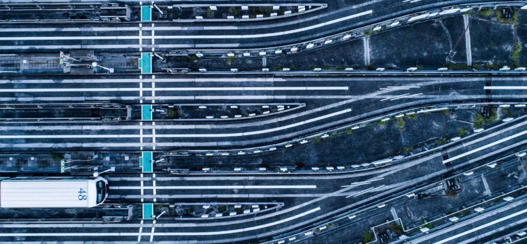 Aerial view of a busy highway filled with various cars and trucks, showcasing the flow of traffic from above.