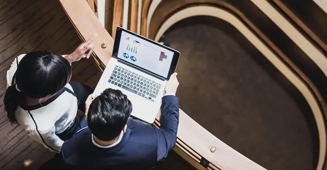 Man and woman looking at a laptop