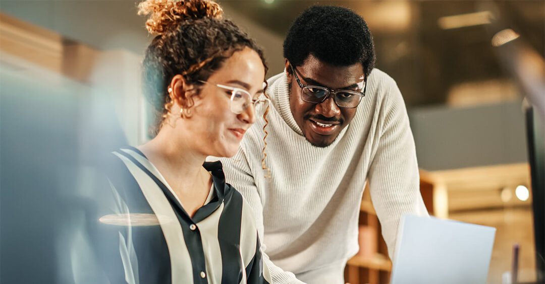 Man and woman looking at a laptop