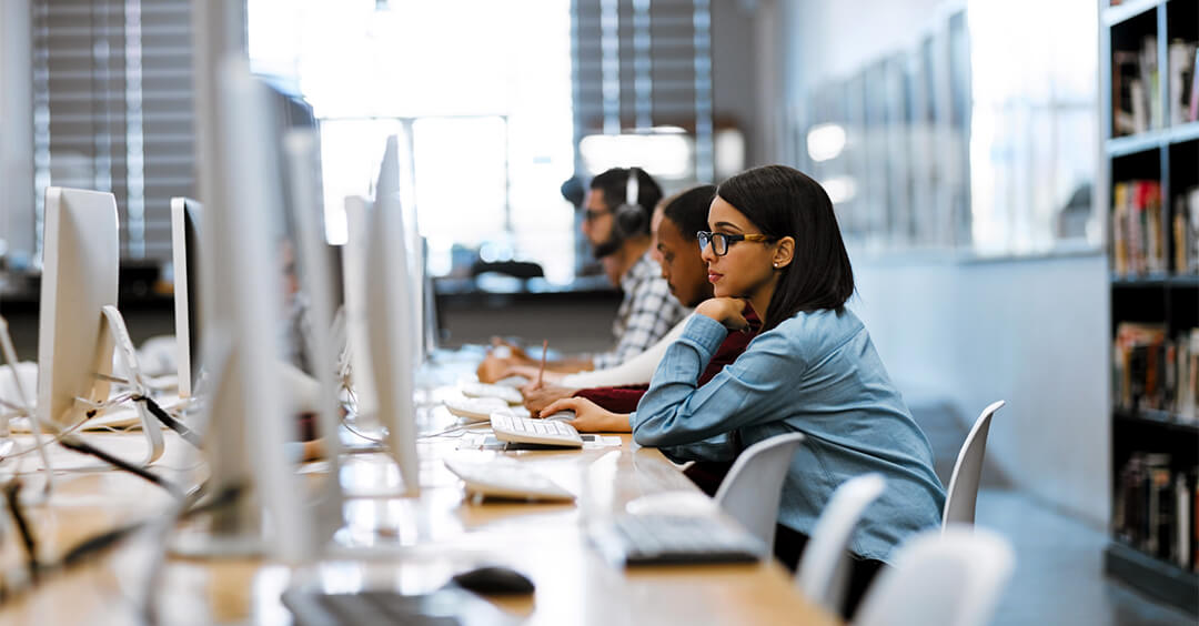 people in a room looking at computers